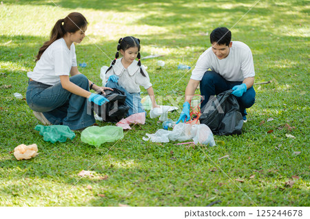 Happy Asian family collecting plastic bottles at the park. 125244678