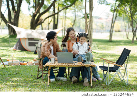 Happy asian family picnic in park, weekend lifestyle outdoors. Happy asian family picnic in park, weekend lifestyle outdoors. 125244684