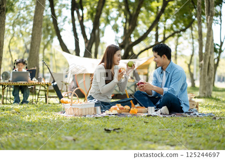 Happy asian family picnic in park, weekend lifestyle outdoors. Happy asian family picnic in park, weekend lifestyle outdoors. 125244697