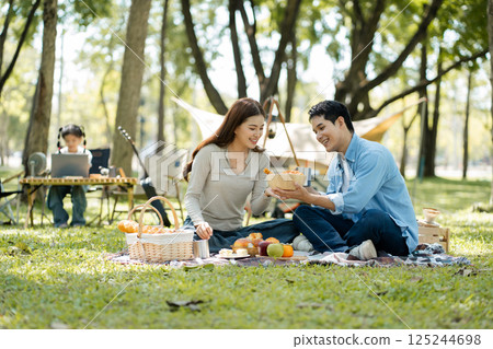 Happy asian family picnic in park, weekend lifestyle outdoors. 125244698