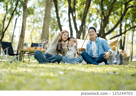 Happy asian family picnic in park, weekend lifestyle outdoors. 125244703