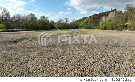 Drought pond soil cracked crust wetland water, swamp drone aerial drying up earth climate change, environmental disaster and earth cracks very, death for plants and animals, soil dry, Europe 125245252