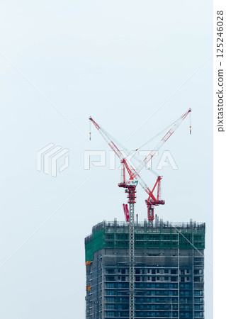 Crane at condominium construction site 125246028