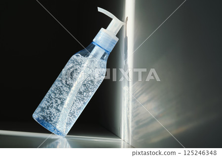 Tube of micellar gel in a ray of sunlight on a shadow background. Tube of micellar gel in a ray of sunlight on a shadow background. 125246348