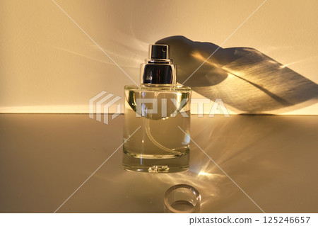 Perfume in the rays of bright sun with beautiful highlights. Perfume in the rays of bright sun with beautiful highlights. 125246657