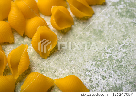 Raw pasta in shape of shells 125247097