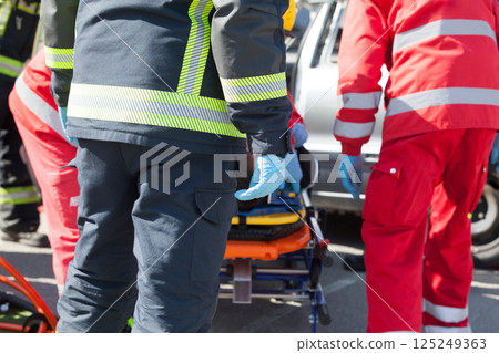 Paramedics and firefighters in urgent rescue operation after a car crash Paramedics and firefighters in urgent rescue operation after a car crash 125249363