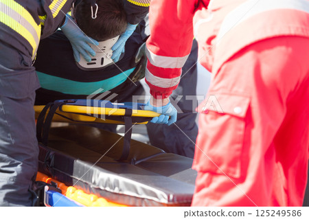 Paramedics and firefighters in urgent rescue operation after accident 125249586