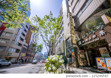 Tokyo cityscape in Japan: View of Shibuya Station and Miyamasuzakashita intersection from Miyamasuzaka with fresh greenery 125249597