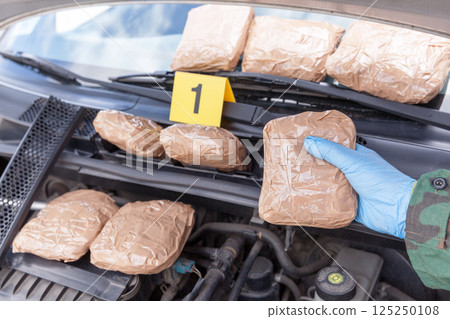 Narcotic smuggling: Hidden drug packages discovered in engine compartment of a car Narcotic smuggling: Hidden drug packages discovered in engine compartment of a car 125250108