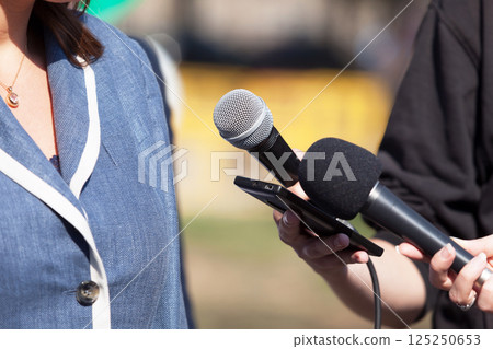 Reporters making media interview with business woman or female politician 125250653