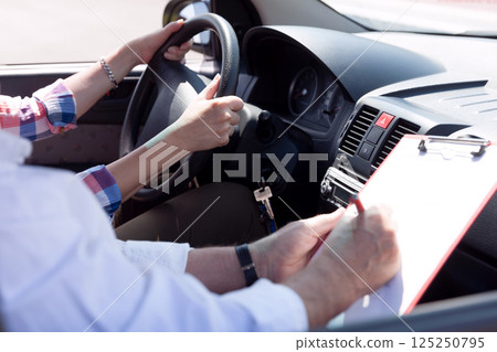 Learner driver student driving car with instructor 125250795