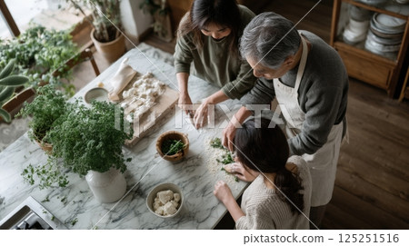 Family Cooking Together in Bright Kitchen 125251516
