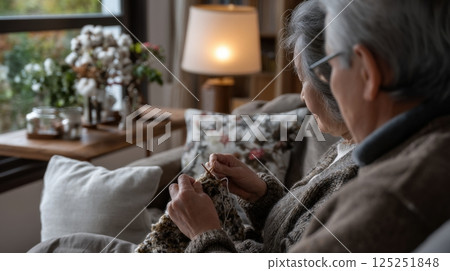 Person Knitting Beige Yarn on Couch Indoor 125251848