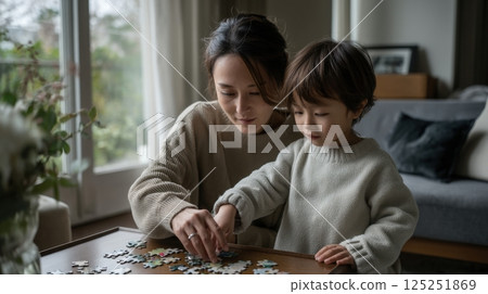 Woman and Child Solving Jigsaw Puzzle Together 125251869