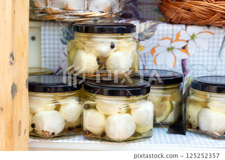 Glass jars with mozzarella balls in brine 125252357