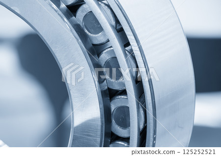 Close up scene the cylindrical rolling bearing parts in the light blue scene. Close up scene the cylindrical rolling bearing parts in the light blue scene. 125252521