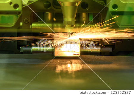The fiber laser cutting machine cut the metal plate with the sparkling light. 125252527