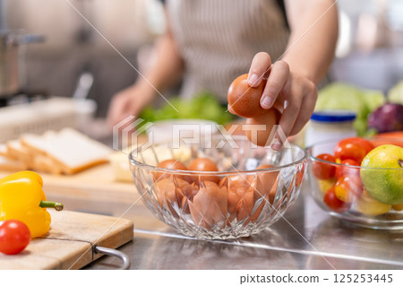 Close-Up of Hand Picking Fresh Eggs in Professional Kitchen Close-Up of Hand Picking Fresh Eggs in Professional Kitchen 125253445