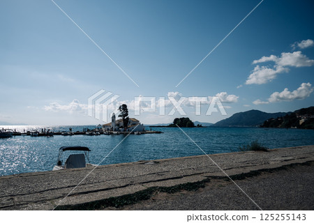 A beautiful blue ocean with a small island in the distance 125255143