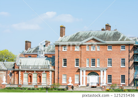 An old red brick building under bright sunlight in Hatchlands Park, a suburb of London An old red brick building under bright sunlight in Hatchlands Park, a suburb of London 125255436