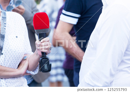 Female reporter making press or media interview Female reporter making press or media interview 125255793