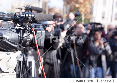Filming media event with a video camera Filming media event with a video camera 125255901