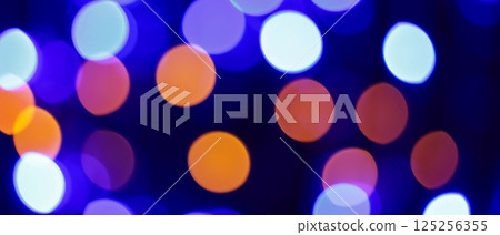 Blurred Abstract Background with Blue, Purple and Orange Bokeh Circles, Vibrant Festive Glow 125256355