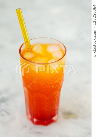 Dirty Soda with Ice Cubes in Tall Glass on Gray Background, Trendy Carbonated Drink Concept 125256364
