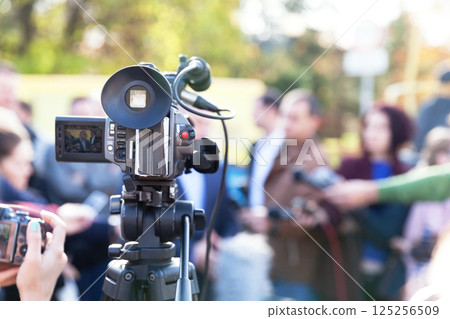 Filming an media event with a video camera. Press conference. 125256509