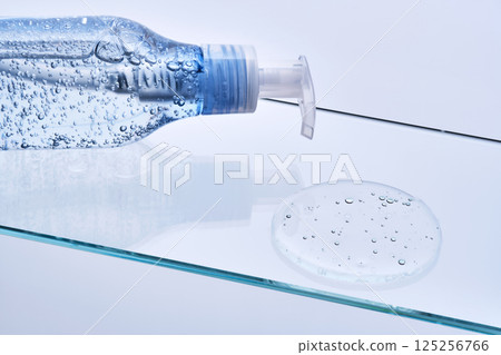 Face wash gel with bubbles on a glass shelf. Face wash gel with bubbles on a glass shelf. 125256766