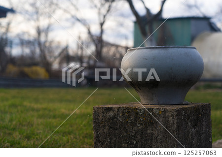 Cast-iron pot stands on a concrete foundation. Soviet cast iron pot 125257063