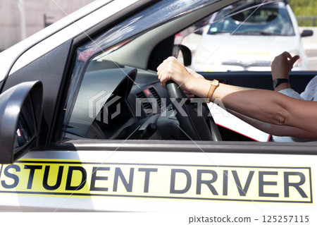 Student driver holding steering wheel during driving lesson 125257115