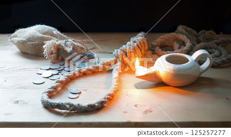 Coins on the table with rope for the gallows Coins on the table with rope for the gallows 125257277