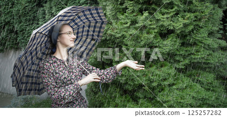 Young girl with big umbrella 125257282
