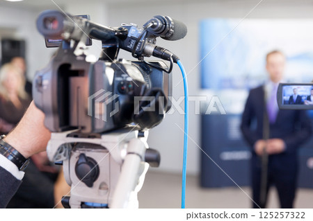 Filming press or news conference with a video camera 125257322