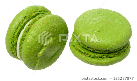 Green macaron with a creamy white filling, isolated background 125257877