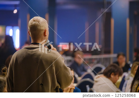 Person speaking to an audience during a conference in a modern venue 125258068