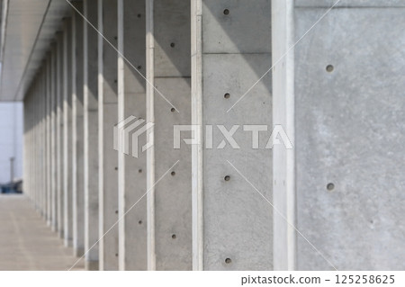 Consecutive exposed concrete pillars 125258625