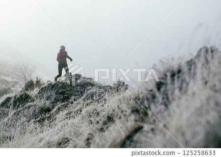 Trail Runner in Misty Mountain Landscape 125258633