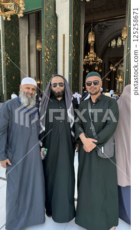 Three Muslim men in Ihram clothing standing in front of the Kaaba during Hajj or Umrah pilgrimage in Mecca, Saudi Arabia. Sacred Islamic journey at Masjid al-Haram Three Muslim men in Ihram clothing standing in front of the Kaaba during Hajj or Umrah pilgrimage in Mecca, Saudi Arabia. Sacred Islamic journey at Masjid al-Haram 125258671