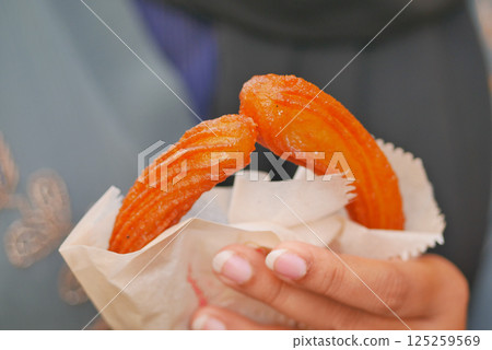 Close-Up of Freshly Prepared Glazed Jalebis In Hands 125259569