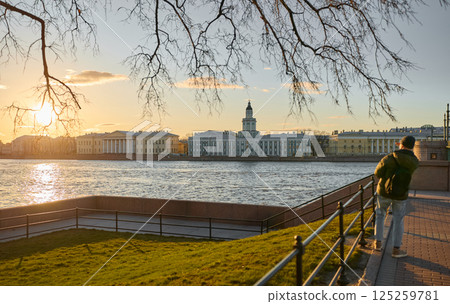 Admiralty embankment with lion monuments at the Palace Bridge at sunset, the Russian State Natural Science Museum in St. Petersburg, established by Peter the Great in 1714 125259781