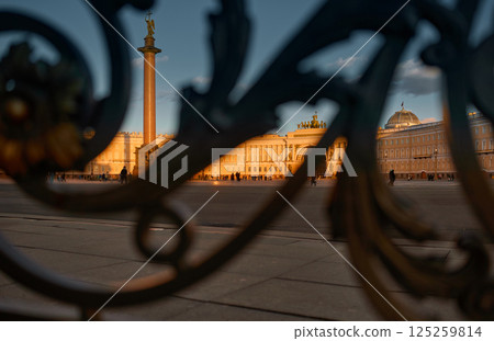 Russia, St. Petersburg, The Palace Square through the ancient wrought-iron railings during sunset, the Alexandrian Column, the Arch of the General Staff 125259814