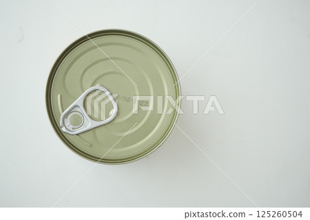 Metal can with pull tab on a plain surface in bright lighting Metal can with pull tab on a plain surface in bright lighting 125260504