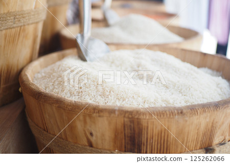 White rice displayed in woven baskets at a local market stall 125262066