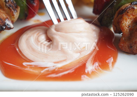Dip made of sauce and mayonnaise served with grilled skewers 125262090