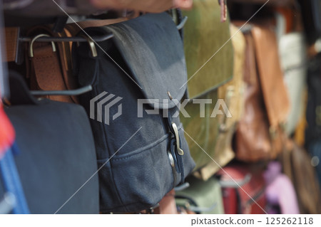 Handcrafted bags displayed in a local market during daytime Handcrafted bags displayed in a local market during daytime 125262118
