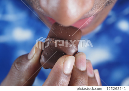 Enjoying a sweet chocolate treat during a casual moment 125262241