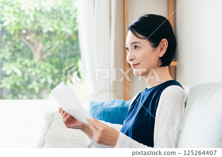 A woman reading a letter A woman reading a letter 125264407